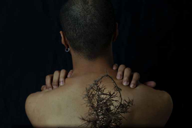 woman with plant on back